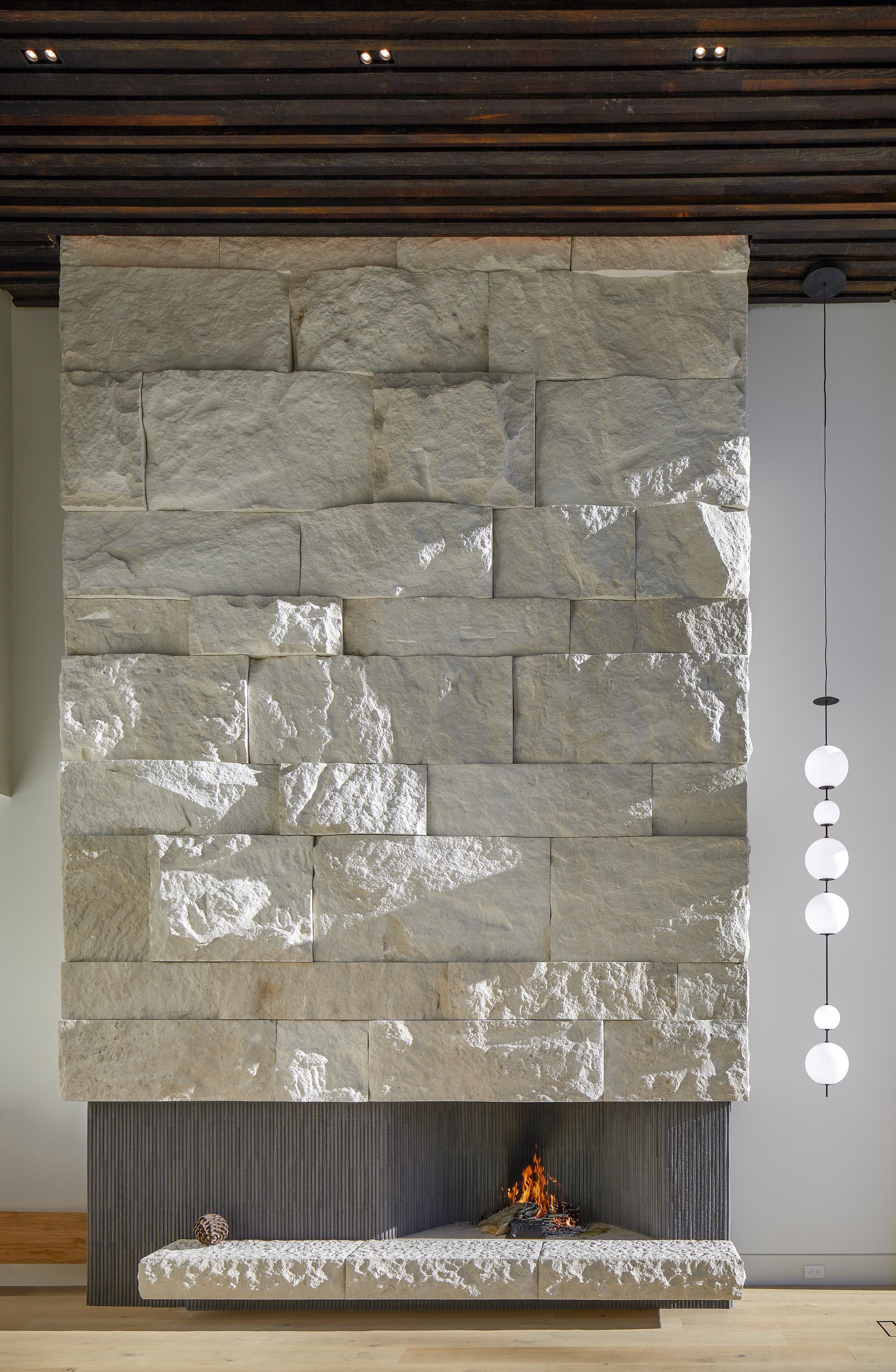 Textured pale stone surrounds the tall fireplace at the home in Port Credit.