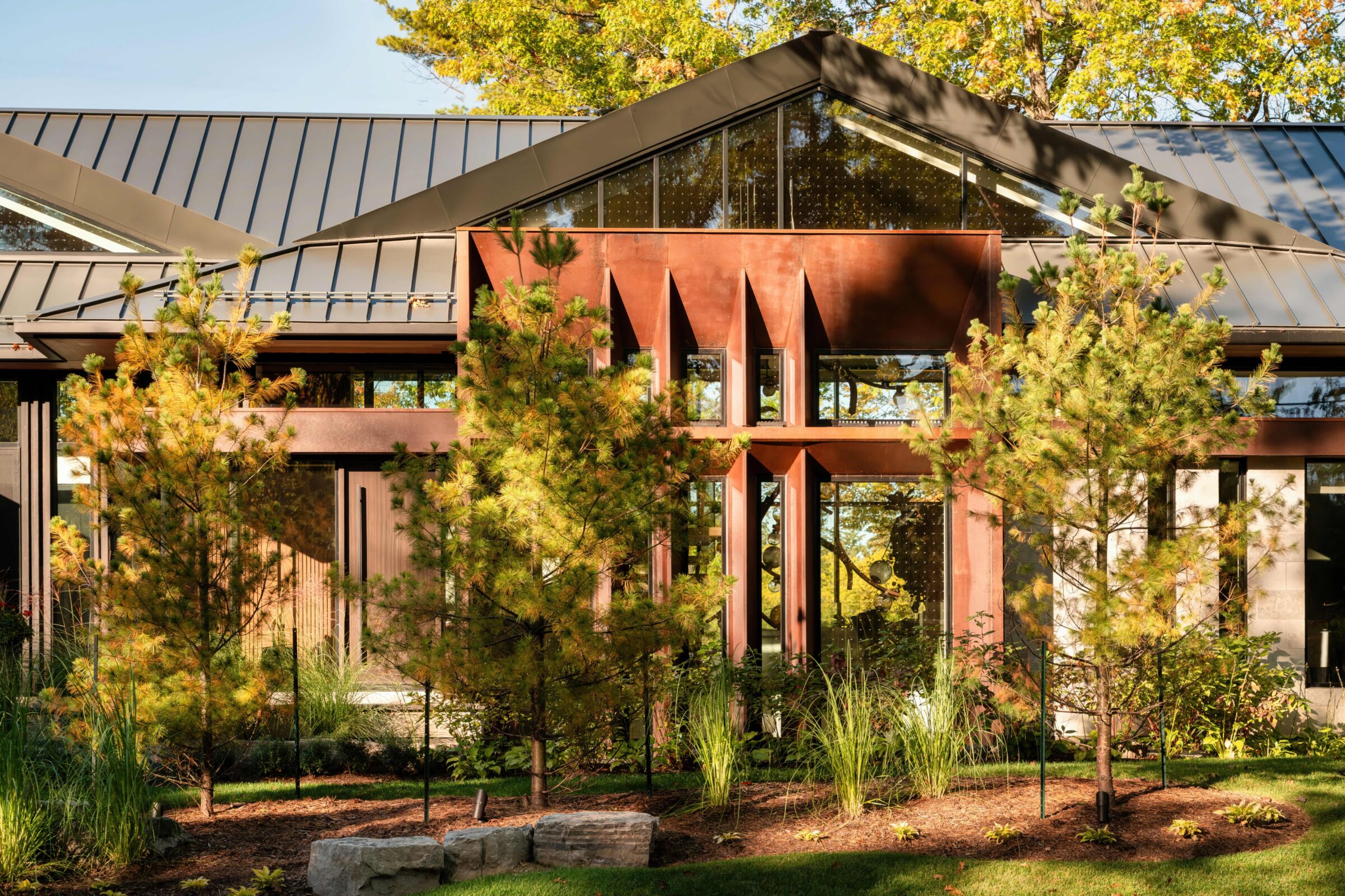 River-facing exterior of Riverside Residence with tall windows and projecting window frames